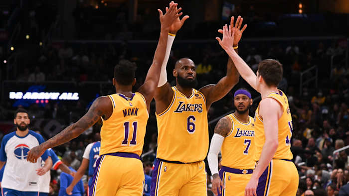 LeBron celebrates with Malik Monk and Austin Reeves